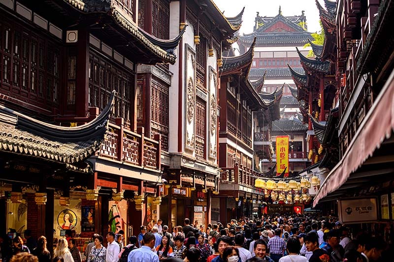 A busy street with ancient Chinese architecture.