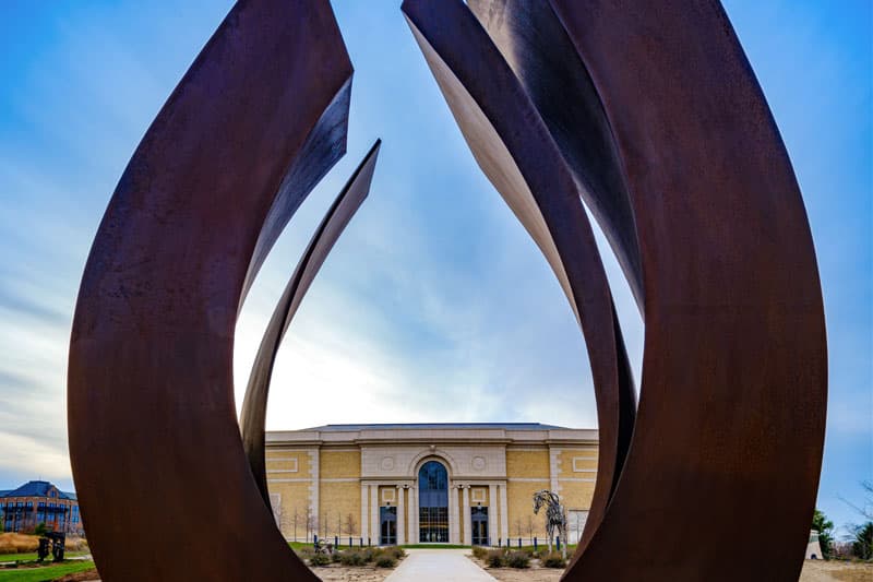 The exterior of Raclin Murphy Museaum of Art peaks through a large horseshoe-shaped sculpture on the east entrance.