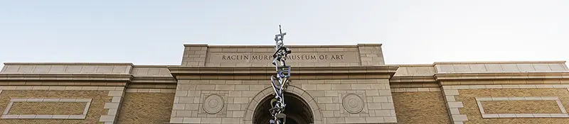 The front of the Raclin Murphy Museum of Art with a focus on the metal scuplture out front
