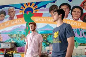 Francis Brockman, left, and Daniel Rottenborn stand in front of colorful mural in Casa Vides.