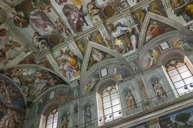 Ceiling of the Sistine Chapel showcasing many of Michelangelo’s frescoes depicting several Old Testament scenes.