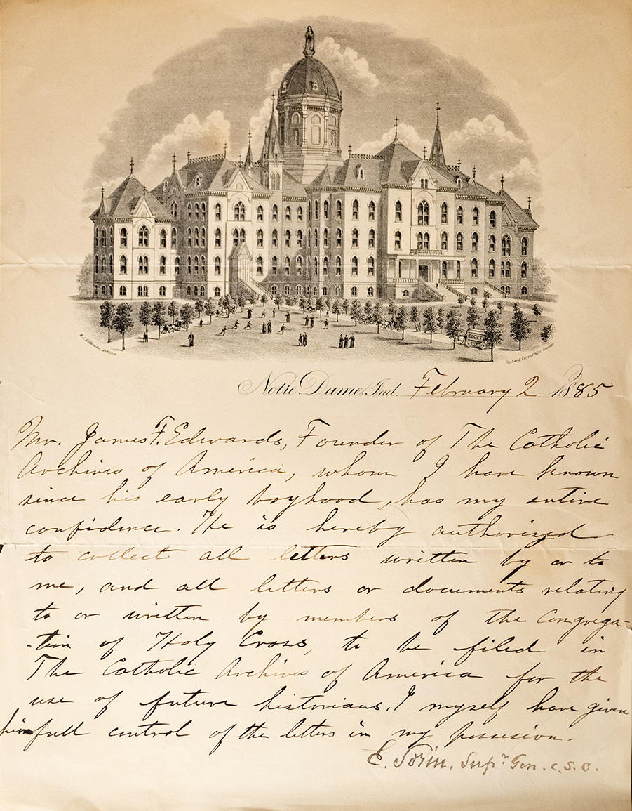 A yellowed letter written in calligraphic hand. At the top is a black and white illustration of the main building at Notre Dame