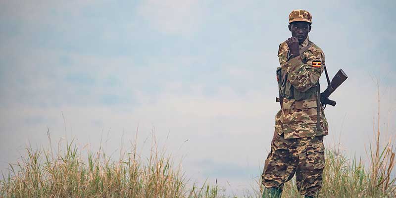Ugandan park ranger patrols in Queen Elizabeth National Park.