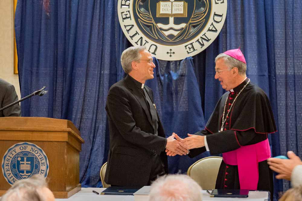 May 9, 2016; University of Notre Dame president Rev. John I. Jenkins, C.S.C. and Archbishop Jean-Louis Brugues, archivist and librarian of the Holy Roman Church, shake hands following a signing ceremony for a memorandum of understanding for collaboration and exchanges between the Vatican Library and Notre Dame. (Photo: Matt Cashore).