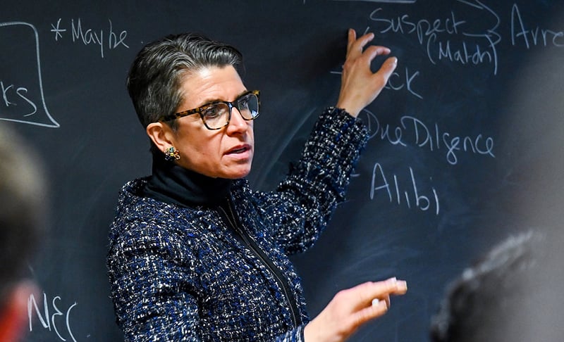 Professor Kirsten Martin working out concepts on the chalkboard for her class