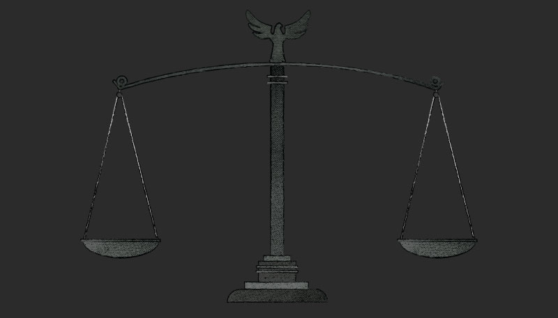 A black and white illustration of the scale of justice.
