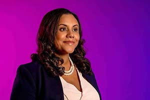 Veronica Root Martinez against a purple background.