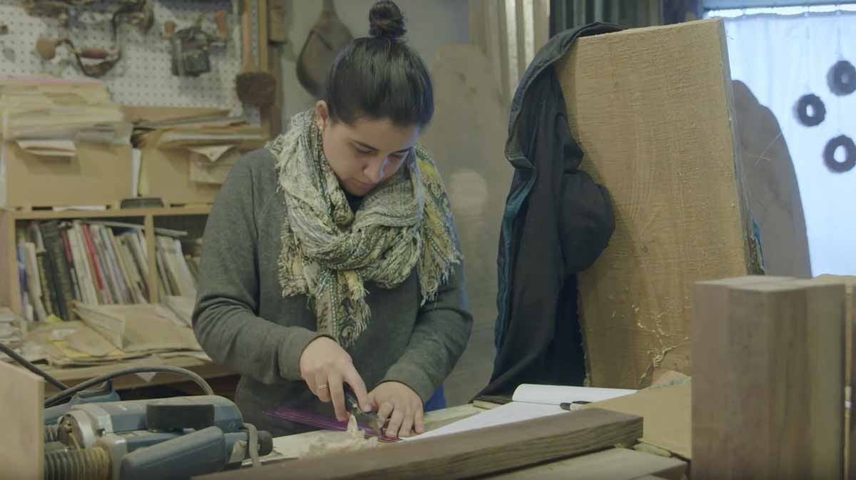 Alejandra Pinto working with wood at Piser Designs, Inc.
